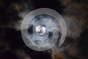 Tamil Nadu, India - June-06-2020: Penumbral lunar eclipse behind clouds photo